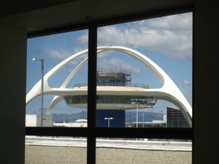a large white building seen through a window