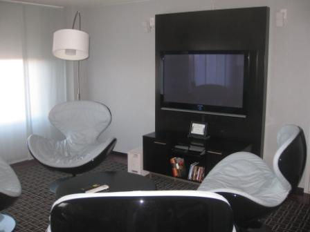 a room with a tv and chairs