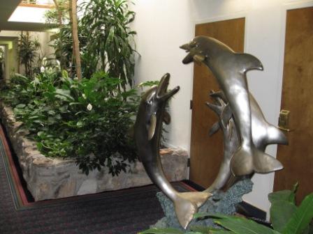 a statue of dolphins jumping out of the air