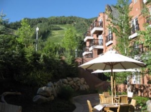 a patio area with a table and umbrella