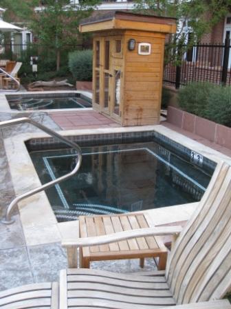 a wooden chair next to a pool