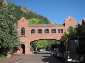 a brick building with a bridge over a road