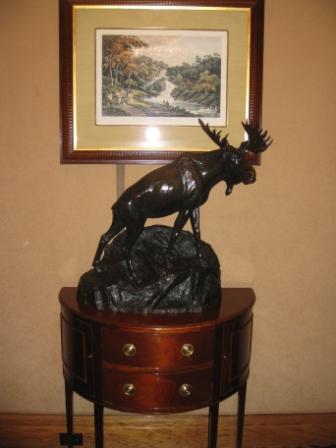 a statue of a moose on a dresser