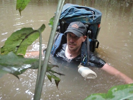 a man in a backpack in a river