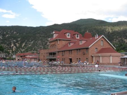 a large building with a pool in the background
