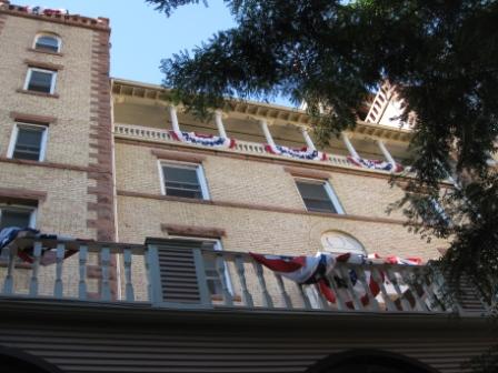 a building with flags on the balcony