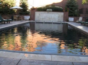 a swimming pool with a brick wall