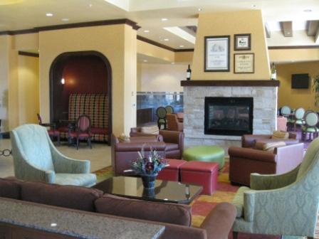 a lobby with a fireplace and chairs