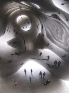 a group of people inside a reflective sculpture