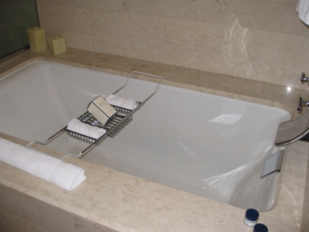 a bathtub with a soap holder