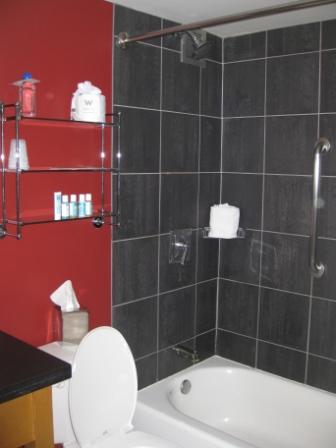 a bathroom with black tile walls