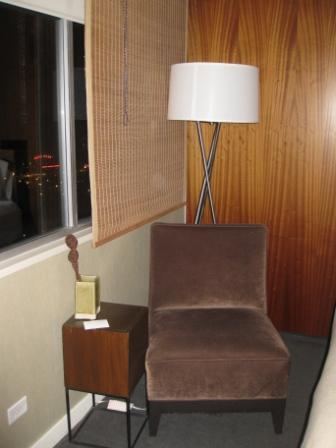 a brown chair next to a lamp