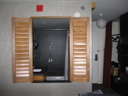 a bathroom with open shutters