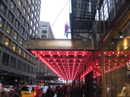 a group of people walking under a red awning