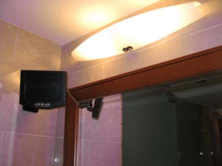a tv on a wall above a door