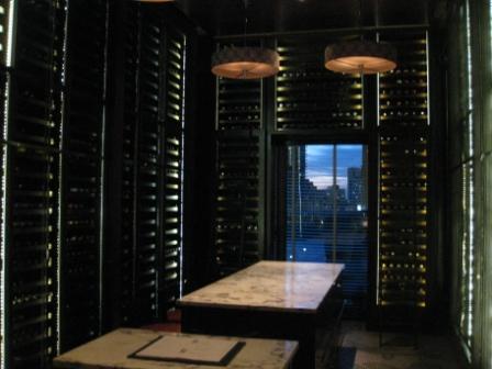 a room with a table and wine bottles