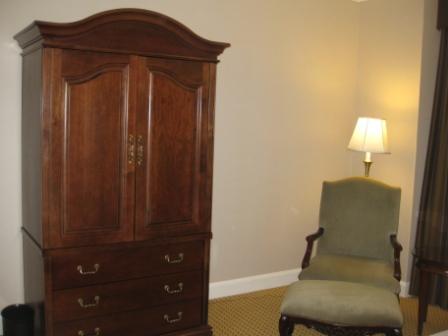 a chair next to a cabinet