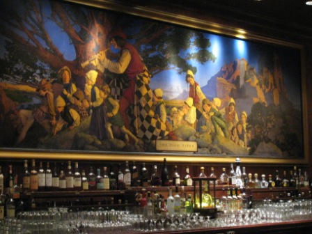 a bar with a painting on the wall