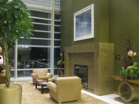 a living room with a fireplace and a plant
