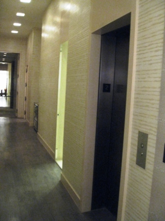 a long hallway with elevator doors