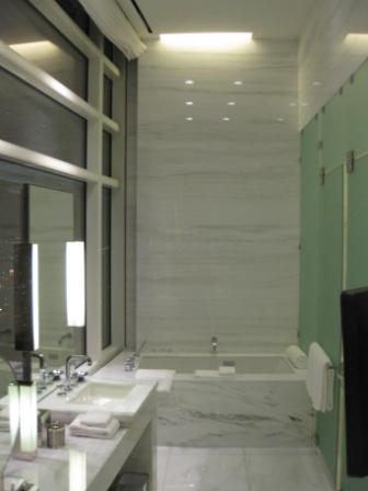a bathroom with marble floor and a tub