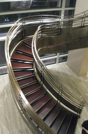 a spiral staircase with metal railing