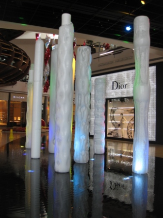 a group of white pillars in a mall
