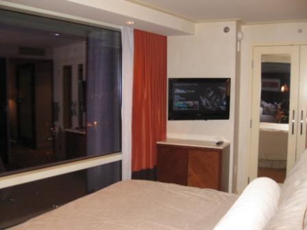 a bedroom with a tv on the wall