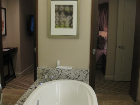 a bathroom with a bathtub and a framed picture on the wall