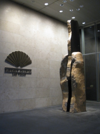 a stone sculpture in front of a building
