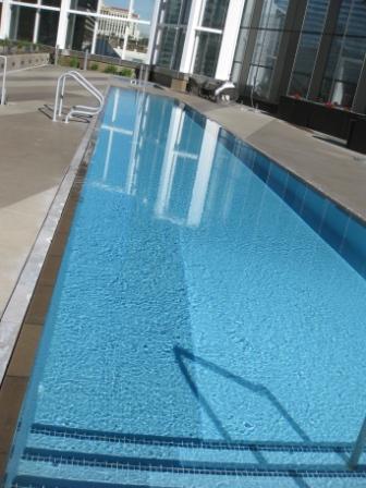 a long rectangular pool with a railing