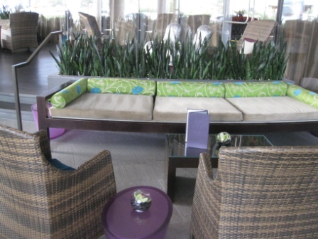 a lounge area with a couch and chairs