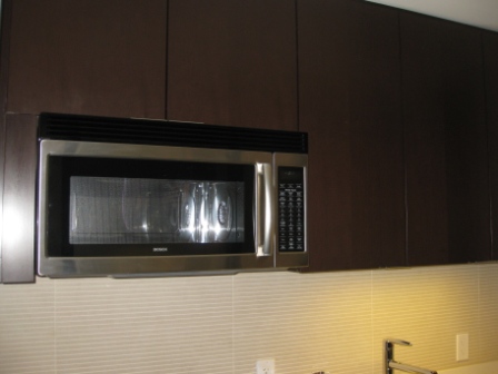 a microwave oven above a cabinet