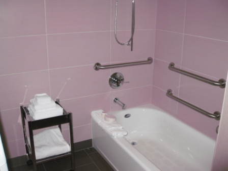 a bathroom with pink tiles