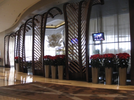 a lobby with a tv and flowers