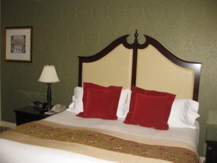 a bed with red pillows