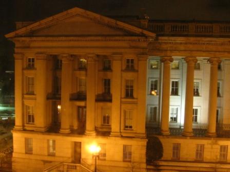 a large building with columns at night