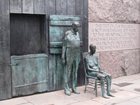 a statue of a man and a woman with Franklin Delano Roosevelt Memorial in the background