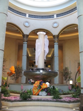 a large white pillared fountain in a building