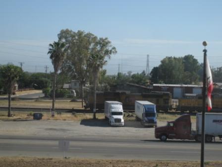 long shot of several trucks parked on the side of a road