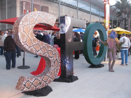a woman standing next to large letters