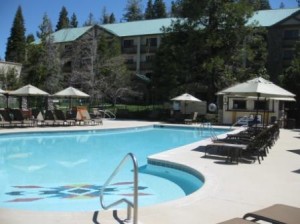 a swimming pool with umbrellas and chairs