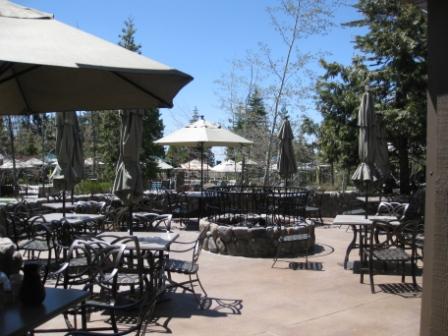 a patio area with tables and umbrellas