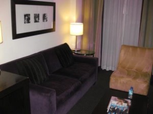 a living room with a couch and a lamp