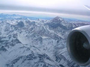 a view of snowy mountains from an airplane