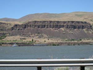 a view of a river and mountains from a highway