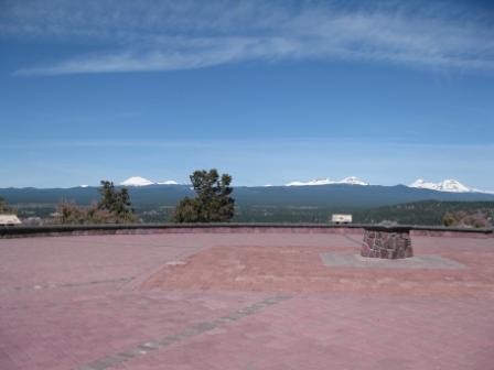a red brick patio with a view of mountains in the background