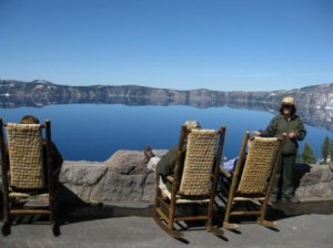 a group of people sitting in chairs overlooking a lake