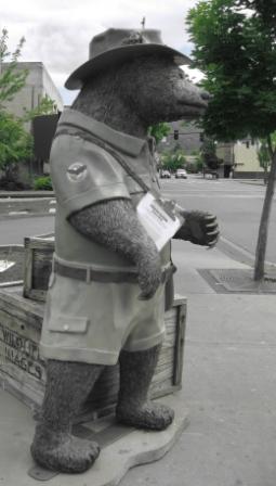 a statue of a bear wearing a uniform