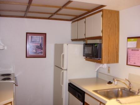 a kitchen with white cabinets and a microwave